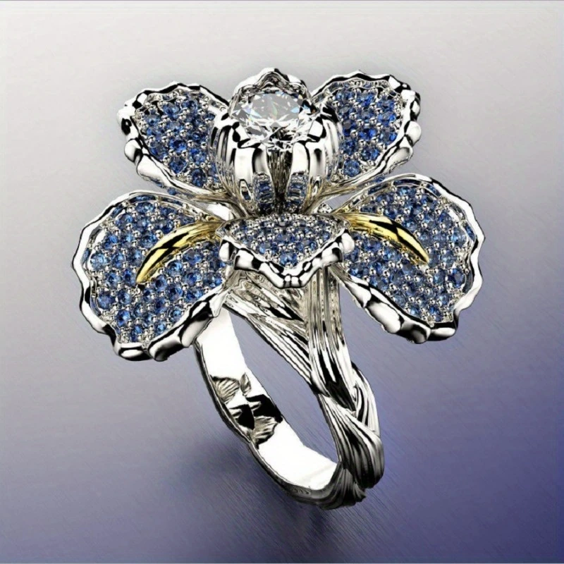 Anillo de plata con flor azul y cristal