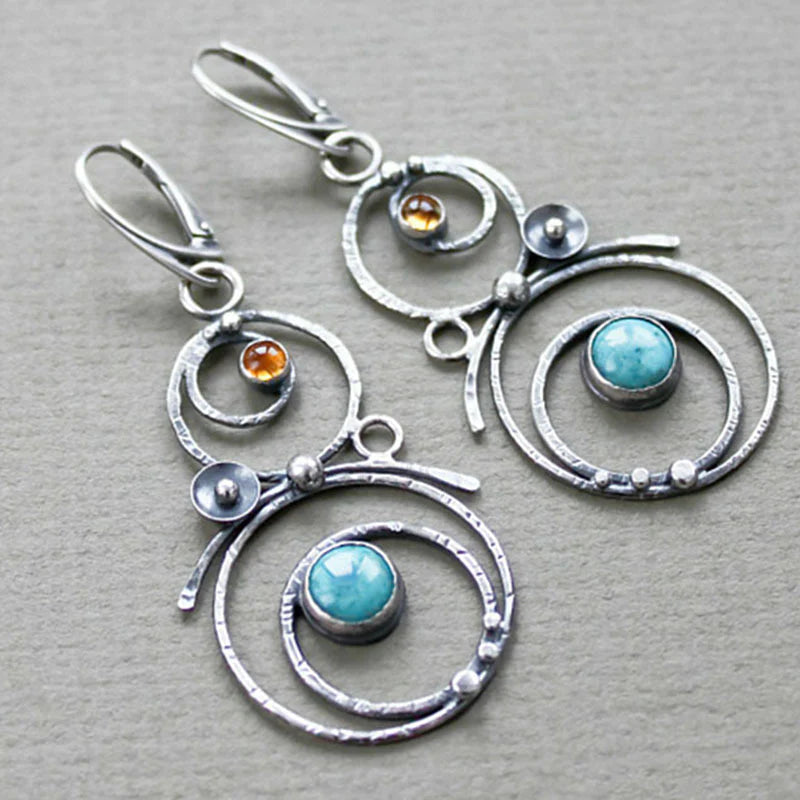Pendientes en espiral hechos a mano con detalles en turquesa y ámbar