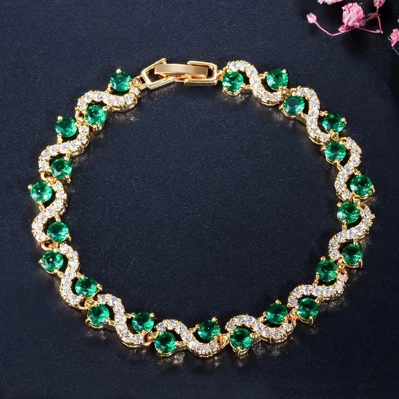 Pulsera de circonitas cúbicas de color verde esmeralda brillante con un elegante diseño de ondas