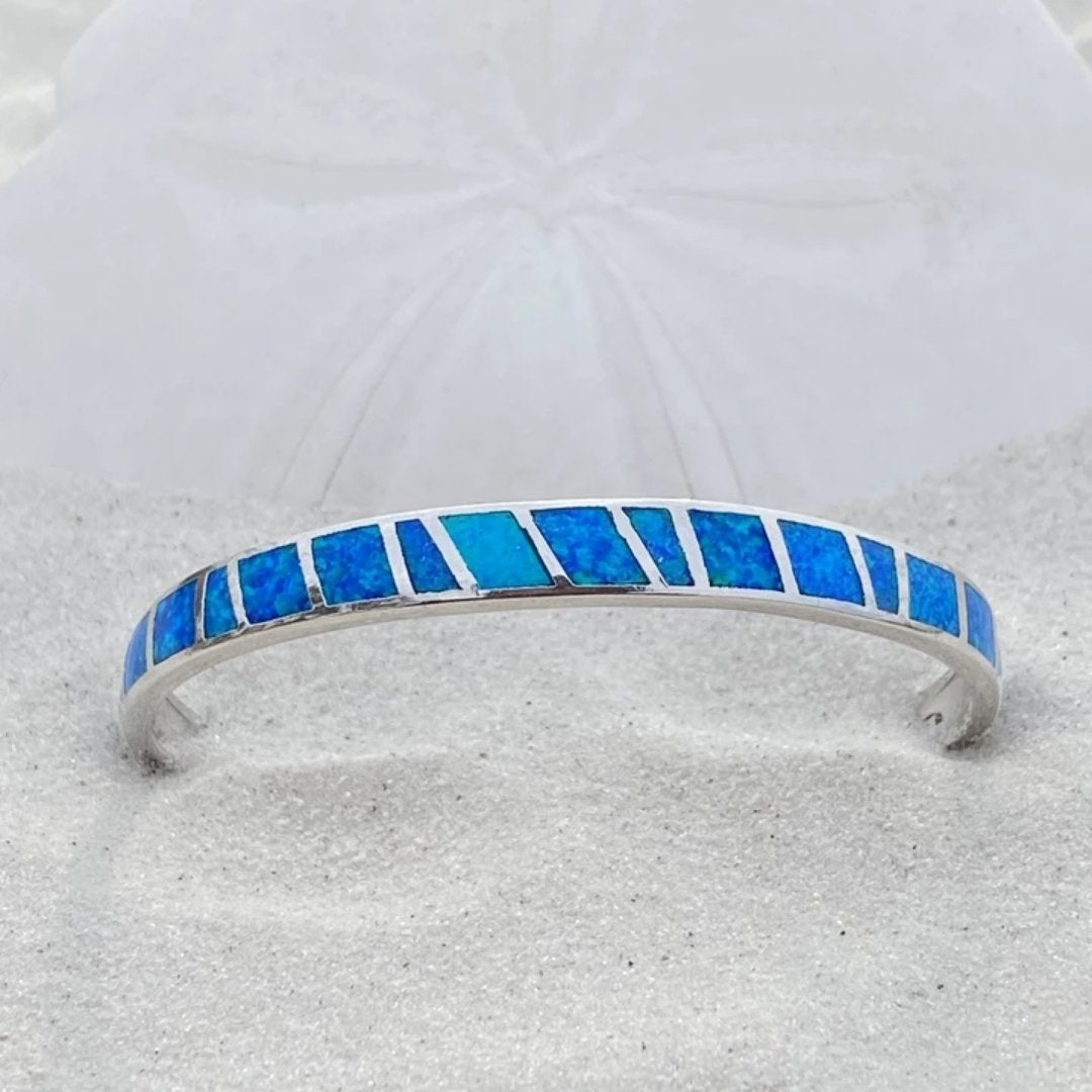 Pulsera con incrustaciones de ópalo azul brillante con diseño de rayas