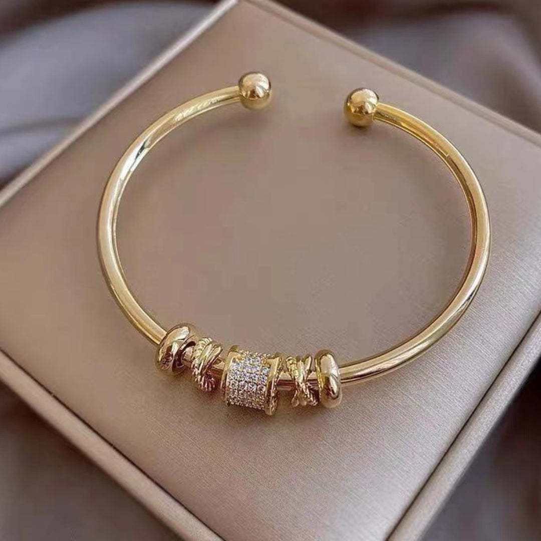 Brazalete brillante con cilindro incrustado de circonitas y elegantes anillos