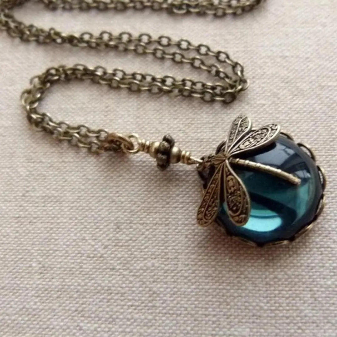 Collar de libélula de bronce con piedra de cristal facetada de color azul intenso
