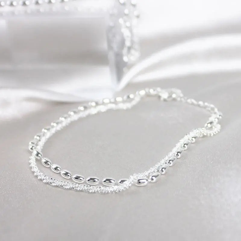Glamorosa pulsera de circonitas con elegante collar de perlas