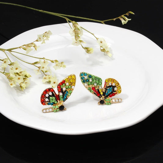 Pendientes de mariposa de colores con pedrería brillante