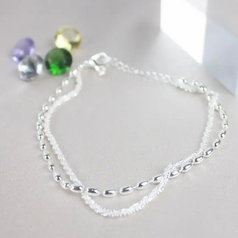 Glamorosa pulsera de circonitas con elegante collar de perlas