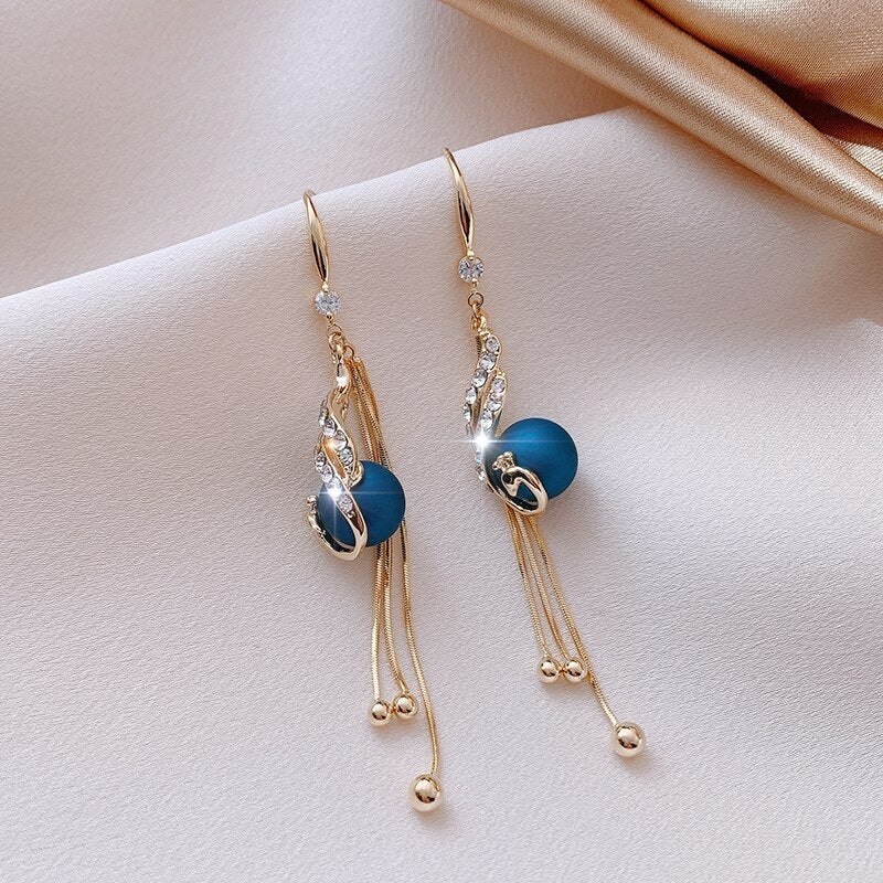 Elegantes pendientes de borlas azules o rojas con decoración de strass