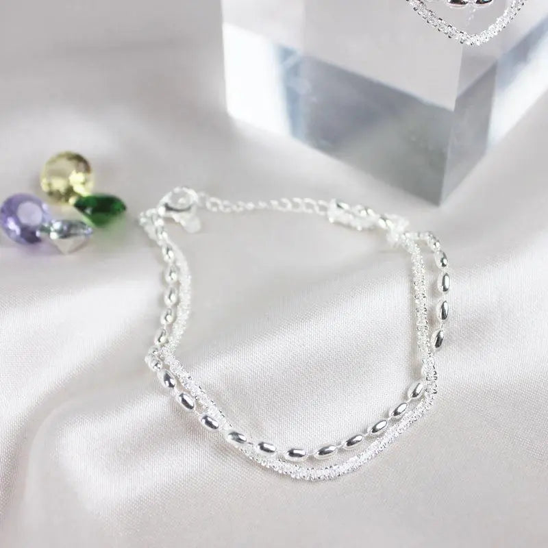 Glamorosa pulsera de circonitas con elegante collar de perlas