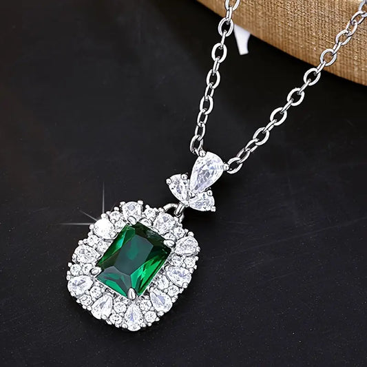 Elegante colgante de esmeralda con halo de circonitas sobre una delicada cadena