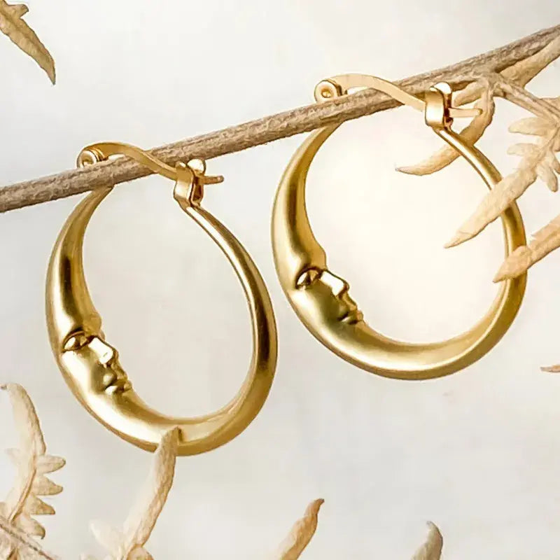 Pendientes de aro elegantes en color dorado con diseño de cara de luna antigua