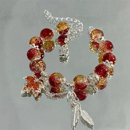 Pulsera de inspiración otoñal con colores de rojo brillante y dorado